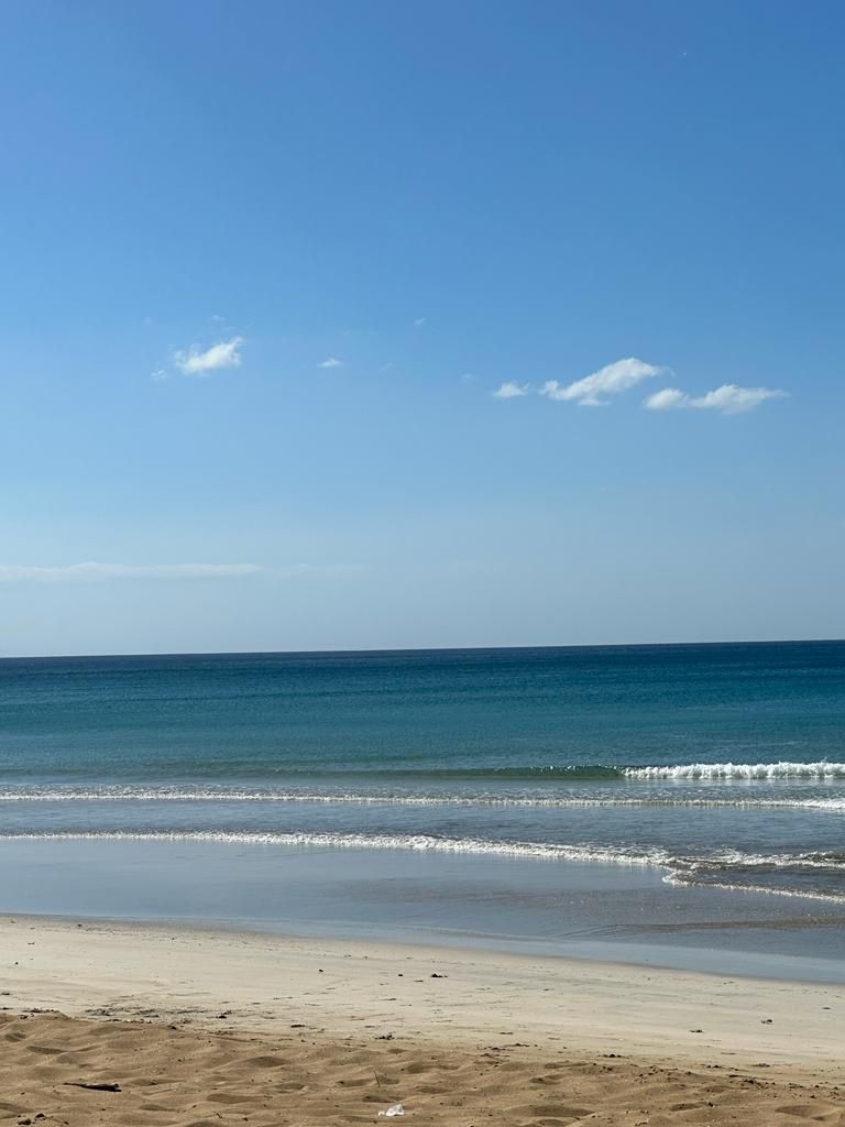 A beach with clear skies and calm water.