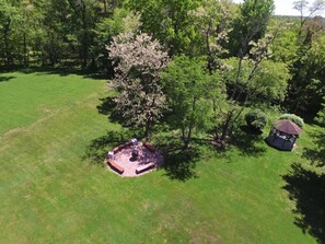 An aerial view of a park with a gazebo, a tree with pink blossoms, and a well-maintained lawn. - Baladerry Inn (Gettysburg)