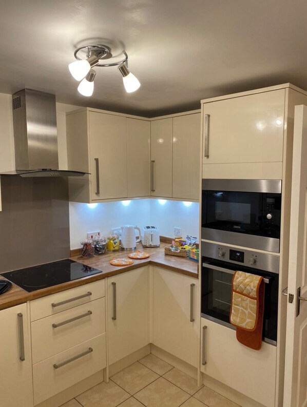 Enjoy cooking in this well-equipped kitchen with an oven, stainless steel range hood, and ample countertop space.