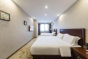 A hotel room with two beds, a nightstand, a lamp, and a view of the hallway. - Hequn Hotel (Xinchang)