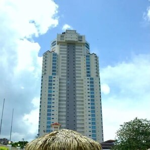 Standing tall, this high-rise building boasts a striking symmetrical facade and numerous windows.