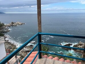 Enjoy breathtaking ocean views from this balcony overlooking the rocky shoreline.