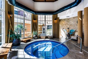 Relax by the pool surrounded by lush greenery and take in the stunning views of the surrounding architecture.