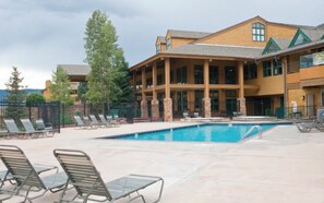 A hotel with a pool area, lounge chairs, and a building with multiple windows and balconies. - Centrally Located Studio just minutes from Granby, Colorado (Granby)