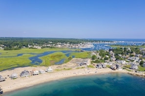 An aerial view of a coastal town with a beach, houses, and a marina. - Scituate Harbor Escape! (Scituate)