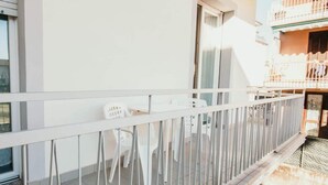 A balcony with a white railing, white plastic chairs, and a small table. - Al 13 Blu 2 - Lakeside L&b (Stresa)