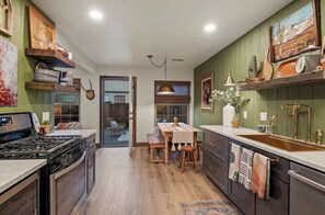 Enjoy cooking in this well-equipped kitchen with a central island, oven, and double sink.