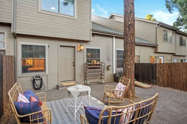 Relax on the patio with wicker furniture and a tree trunk centerpiece.
