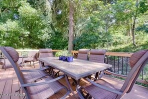 Enjoy al fresco dining on the deck surrounded by lush greenery.