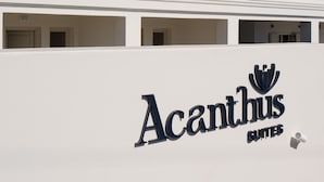A white building with the sign "Acanthus Suites" indicating a hotel or accommodation. - Acanthus Oia-Suites With Private Hot Tub (Santorini)