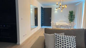 Deluxe Apartment | Living area | 36-inch Smart TV with cable channels