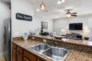 Enjoy cooking in this well-equipped kitchen with a double sink and stainless steel appliances.