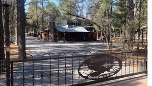 A campground with a covered picnic area and a fenced parking lot. - Fully fenced yard, dogs welcome!  (Lakeside)