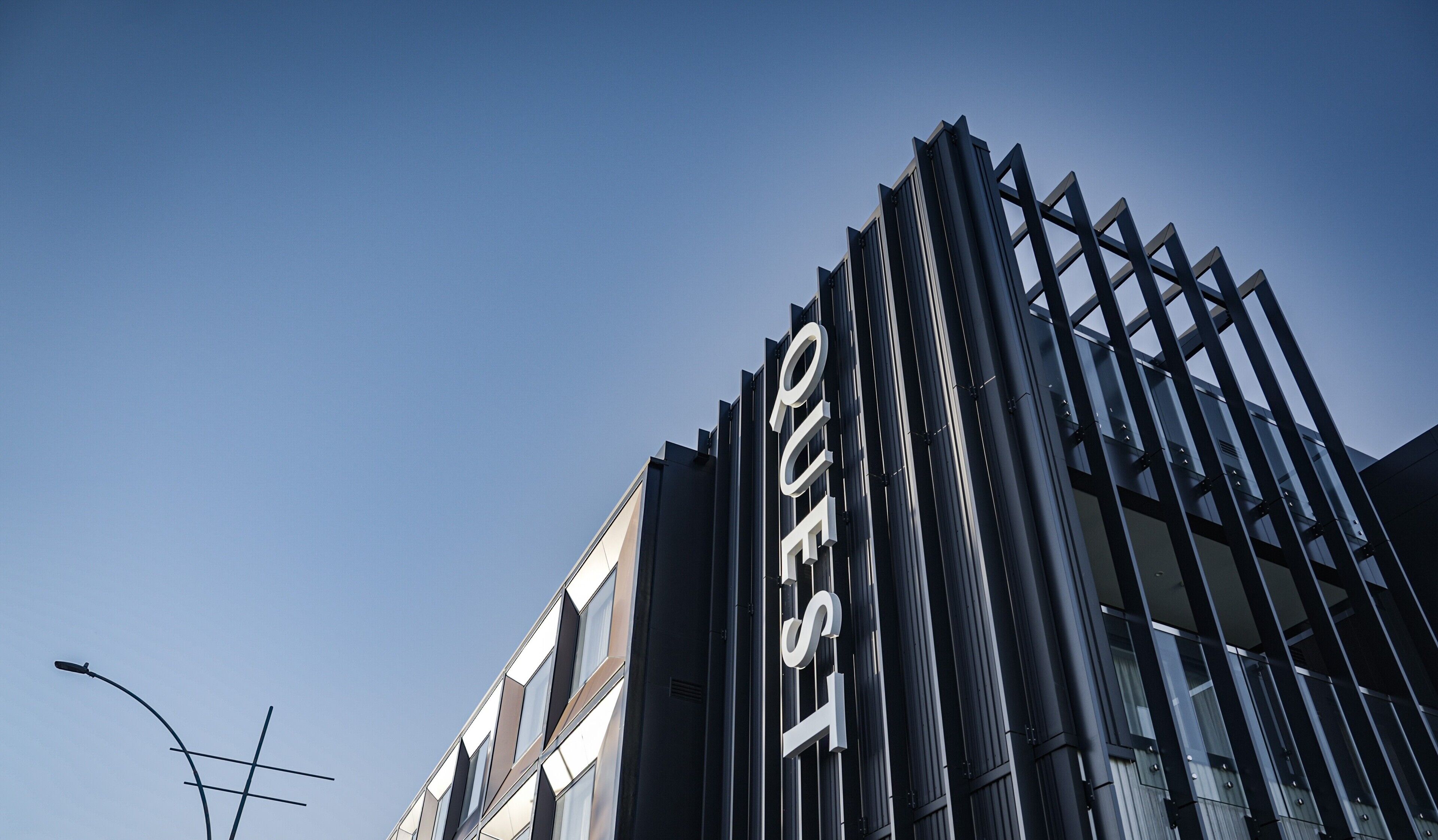 A modern building with a prominent 'POLE WEST' sign.