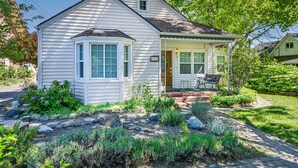 A two-story house with a front porch, a small garden, and a mailbox. - Charming 4BR Home in a Great Downtown Location (Mount Shasta)