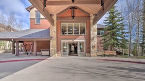 A building with a stone facade, a covered entrance, and a clear view of the interior through the glass doors. - Fabulous Grand Timber Lodge Ski In and Ski Out Resort in Breckenridge (Breckenridge)