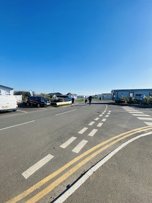 Guests can park their vehicles in designated spaces near the building.