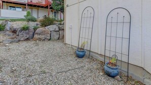 A building with a white exterior, two arched windows, and a gravel driveway. - Private Loft with trail access to Boise Foothills - Pets Welcome! (Boise)