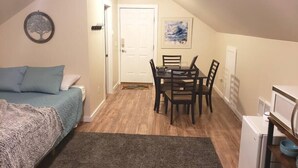 A small, cozy room with a bed, a dining table, and a kitchenette. - Private Loft with trail access to Boise Foothills - Pets Welcome! (Boise)