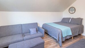 A small, cozy room with a sofa and a bed. - Private Loft with trail access to Boise Foothills - Pets Welcome! (Boise)