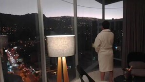 A room with a large window overlooking a cityscape at night. - Beautiful Penthouse in the best area of the LP city (Zona Calacoto La Paz)