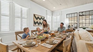 A dining room with a wooden table set for a meal, surrounded by chairs. - ✨ Summer Lane | Golf Cart | Heated Private Pool*  & Walk to Beach | Elevator | FREE Parasailing (Santa Rosa Beach)