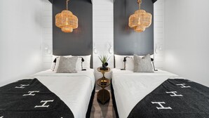 A modern hotel room with two beds, a central nightstand, and hanging wicker lamps. - ✨ Summer Lane | Golf Cart | Heated Private Pool*  & Walk to Beach | Elevator | FREE Parasailing (Santa Rosa Beach)