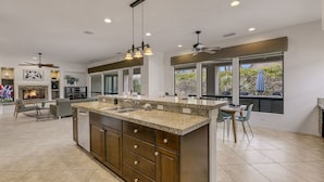 A spacious kitchen with a large island, built-in appliances, and a dining area with a view.