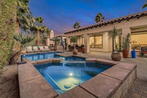 A swimming pool with a tiled deck, surrounded by potted plants and lounge chairs. - Casa De Amore: Pool, Spa, Casitas, Built-n BBQ! (Indio)