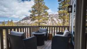 A balcony with wicker furniture, a round table, and a view of a mountain range. - Kirkwood Mountainside Cabin w/Views, Walk to Lifts (Kirkwood)