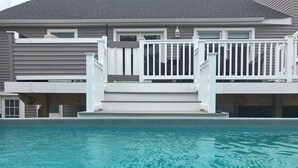 A residential property with a swimming pool, a two-story house, and a white fence. - Short Block to The Beach! Newly Remodeled With Pool & Hot Tub! (Brant Beach)