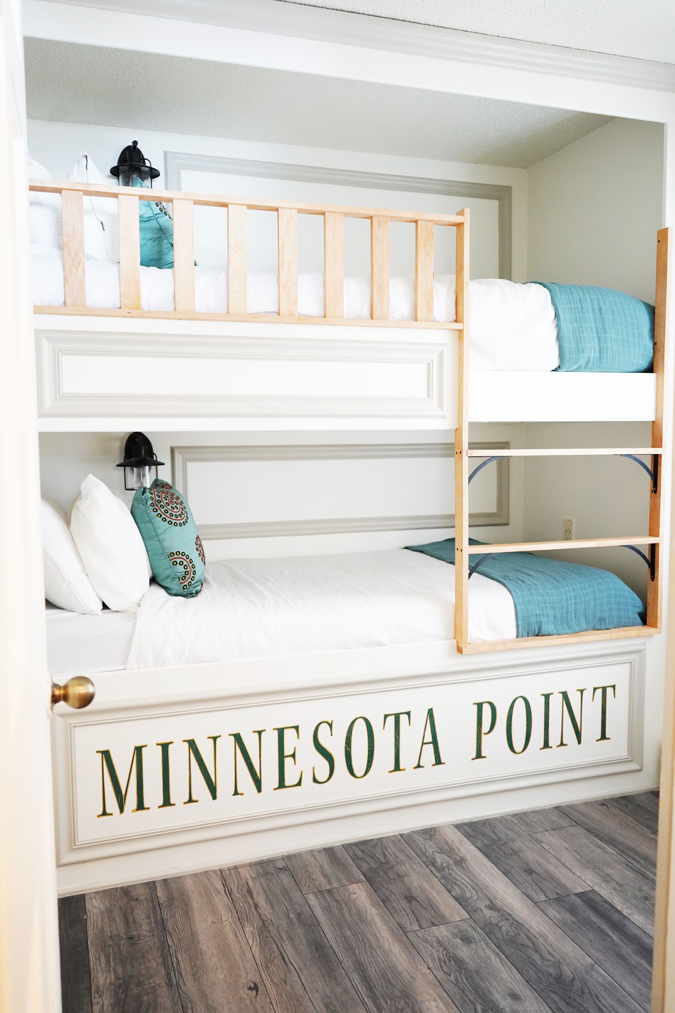 A bunk bed room with a sign reading "MINNESOTA POINT".