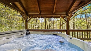 A hot tub under a wooden gazebo surrounded by trees. - Hocking Hills Secluded Cabin • Hot Tub • Fireplace (Logan)