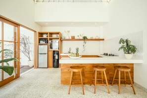 Enjoy casual dining at the central island with bar stools, featuring appliances and large windows with views of the surrounding area.