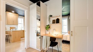 A modern, open-plan living space with a kitchen, dining area, and a cozy bedroom.