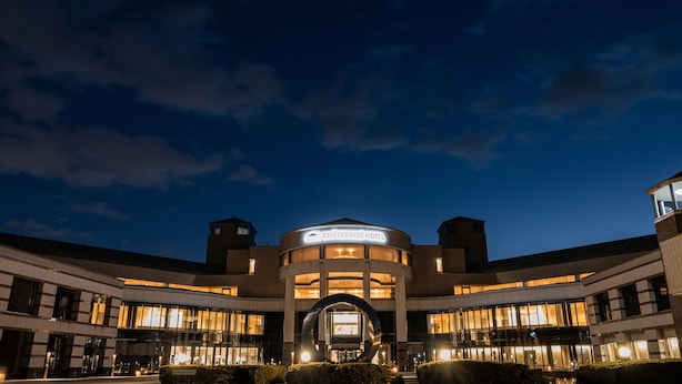 A modern hotel with a circular central atrium, multiple floors, and a well-lit facade. - Chateraise Hotel Nirasaki Forest (Nirasaki)