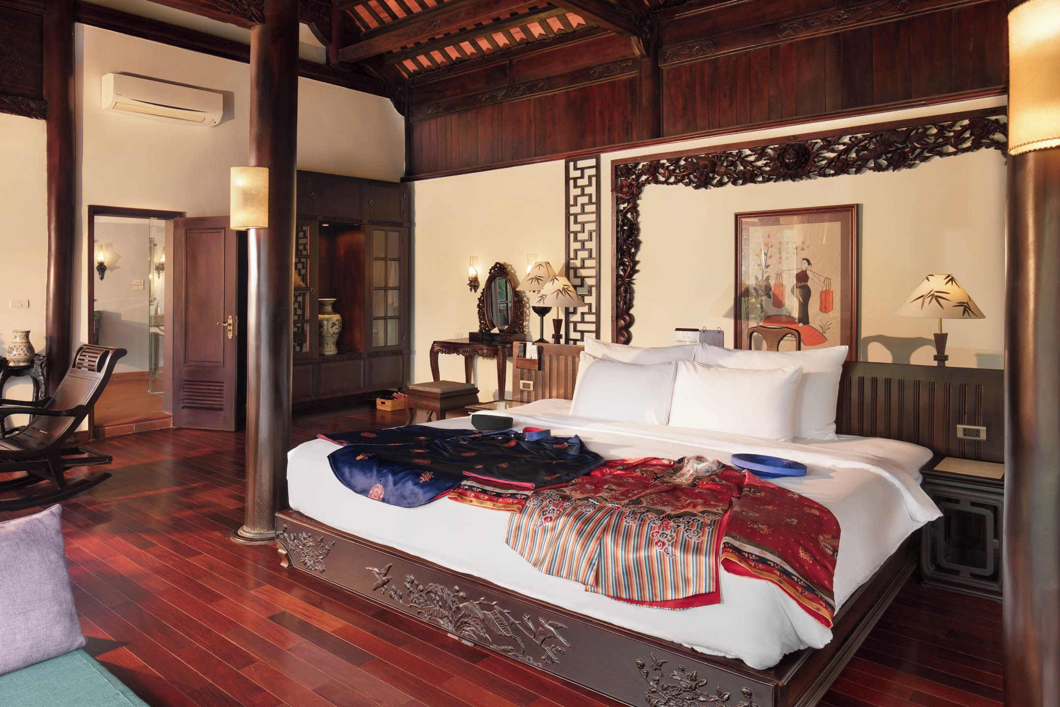 A traditional room with a bed, wooden furniture, and decorative elements.