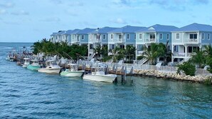 A waterfront property with a row of boats docked in front.