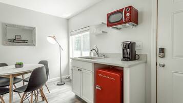 Fridge, microwave, coffee/tea maker, cookware/dishes/utensils