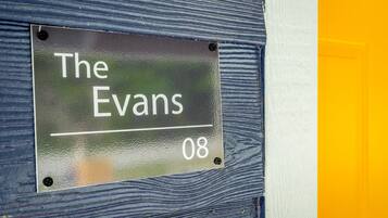 A sign with "The Evans" and the number "08" on a textured wall.