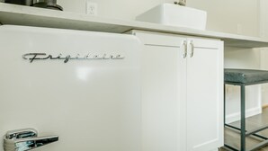 A white refrigerator with the brand name "Frigidaire" on the door.