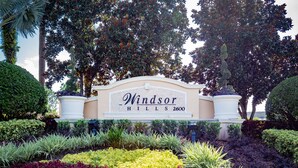 A sign for Windsor Hills with a landscaped garden in front. - The Wish House, just miles from Disney World (Four Corners)