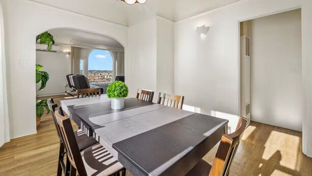 A modern dining area with a large table, chairs, and a potted plant. - Breathtaking View 2BD/1BTH Unit in Central SD (San Diego)