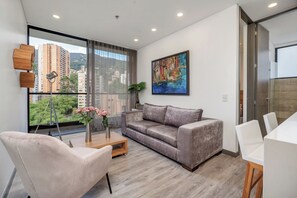 Apartment, 2 Bedrooms (1204) | Living area | 50-inch Smart TV with cable channels, TV - Apartamentos Class Suites by HOUSY HOST (Medellín)