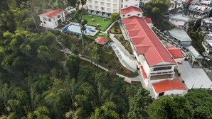 An aerial view of a resort with multiple buildings, a swimming pool, and lush greenery. - Fortune Resort Kalimpong - Member ITC Hotels' Group (Kalimpong)