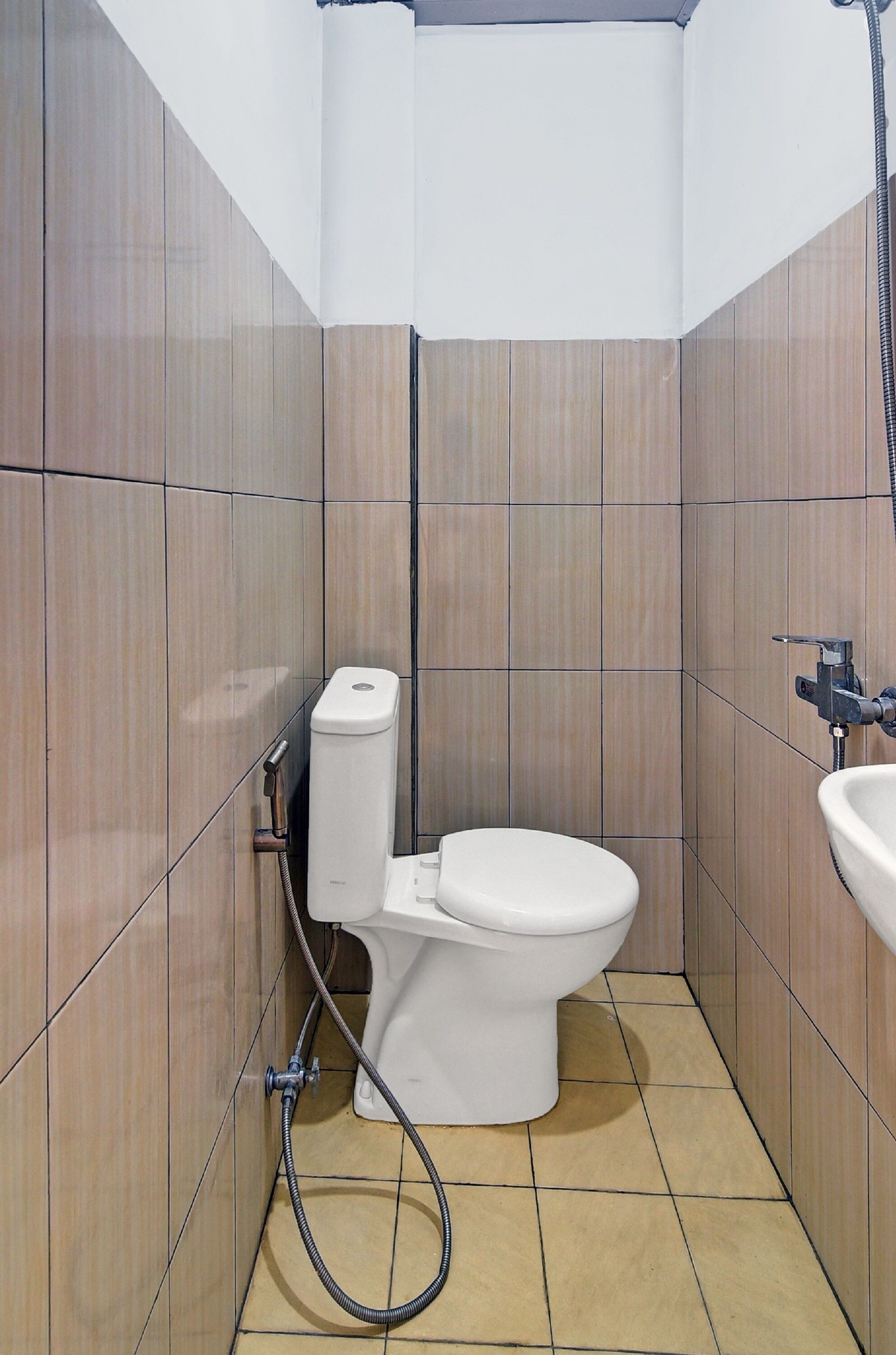 A small bathroom with a toilet, a sink, and a shower.