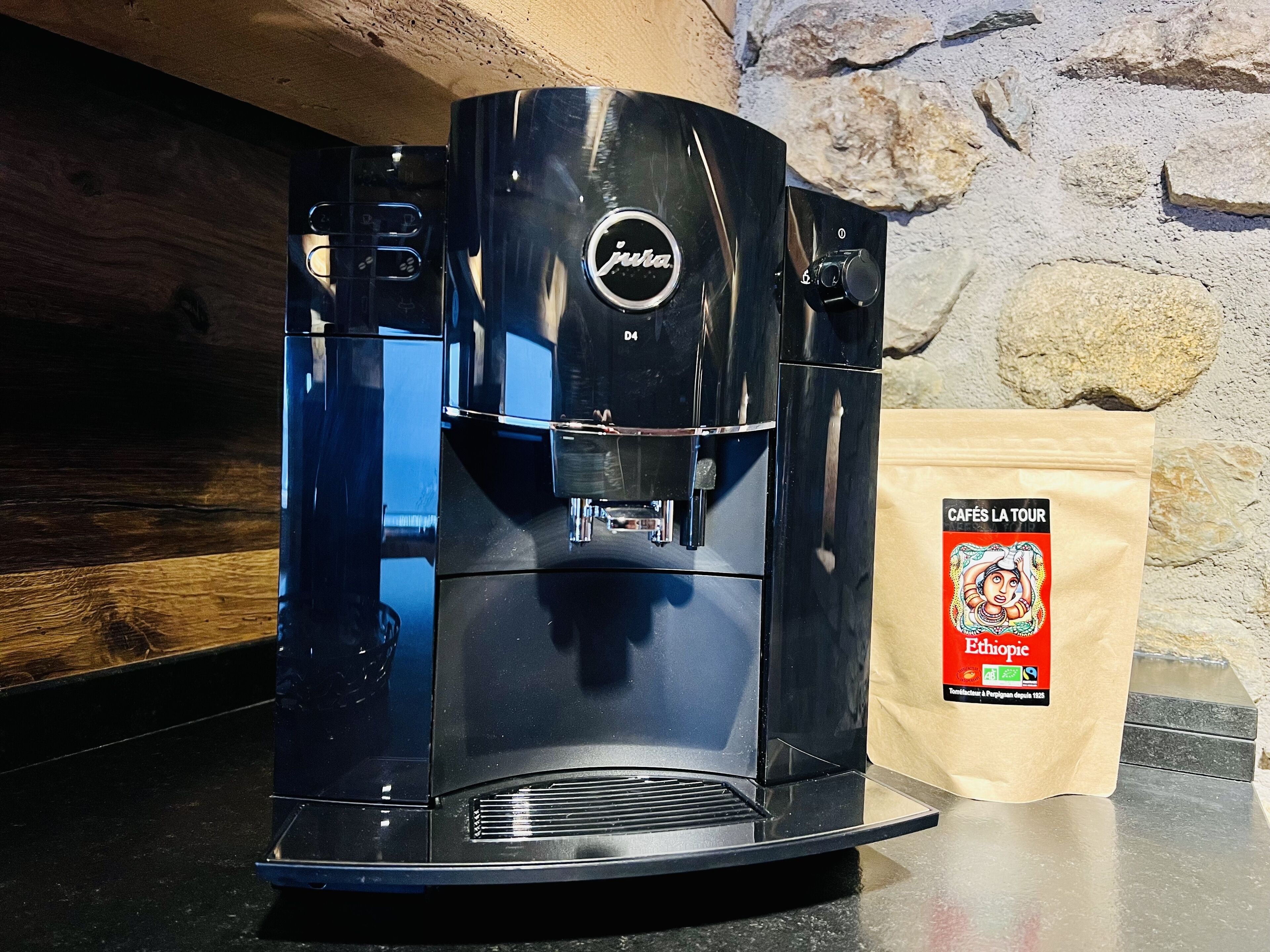 A coffee machine with a control panel and a bag of Ethiopian coffee next to it.