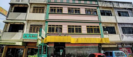 A multi-story building with a ground-level shop and upper residential units.