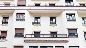 A multi-story building with balconies, large windows, and a flat facade. - GRAN VIA SUITE: superior apartment for 6 PAX. 2min from the beach (San Sebastián)