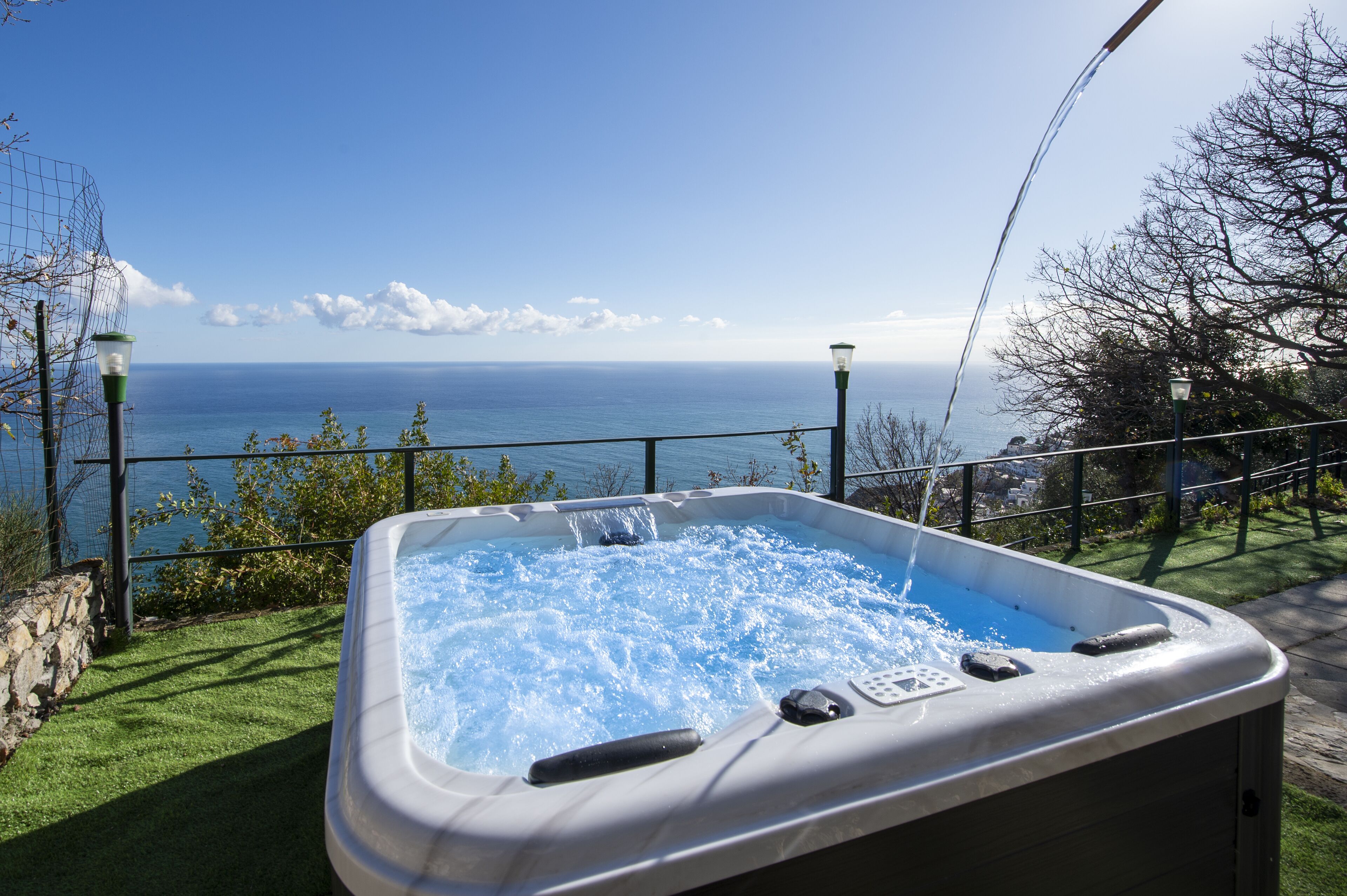 A hot tub with a view of the ocean.